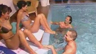 Two couples fuck by pool